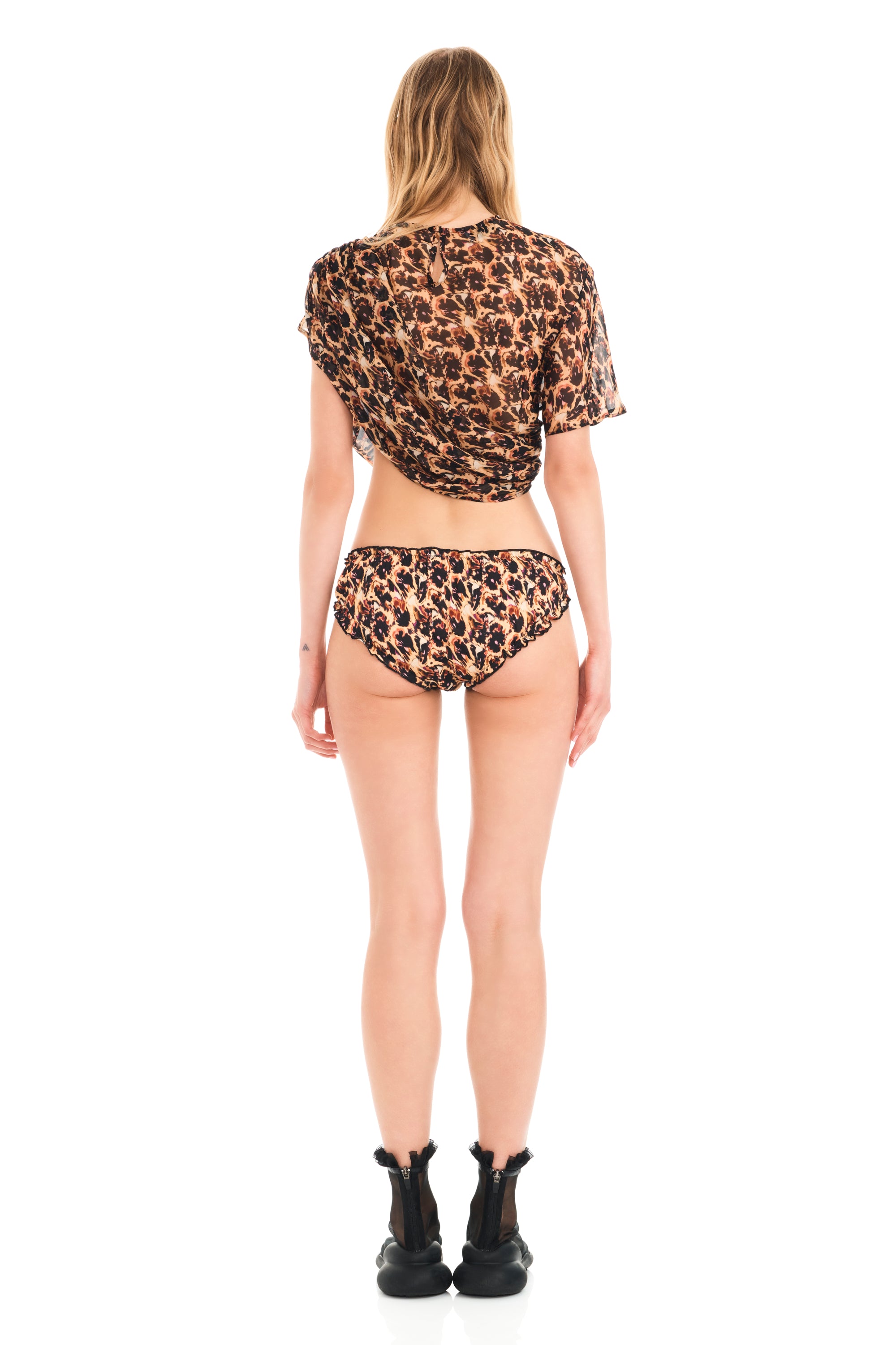 One sleeve top with delicate ruching and artful draping effect on the side. Chiffon, semi-sheer.