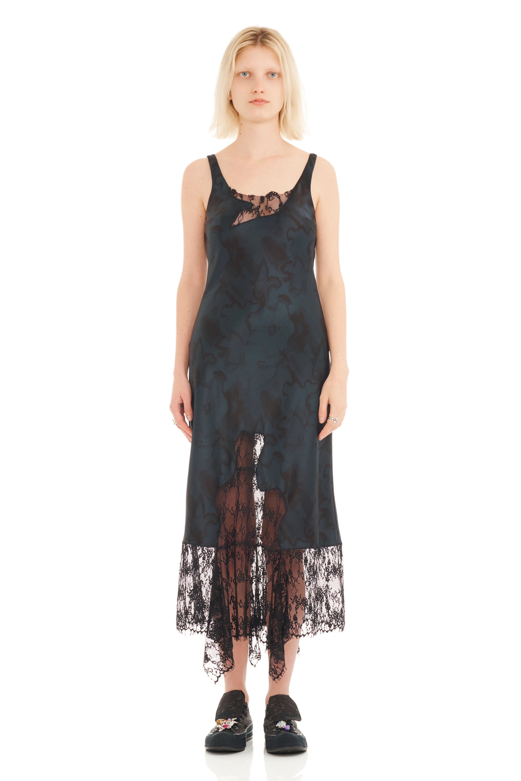 Woman wearing a black lace dress on a white background