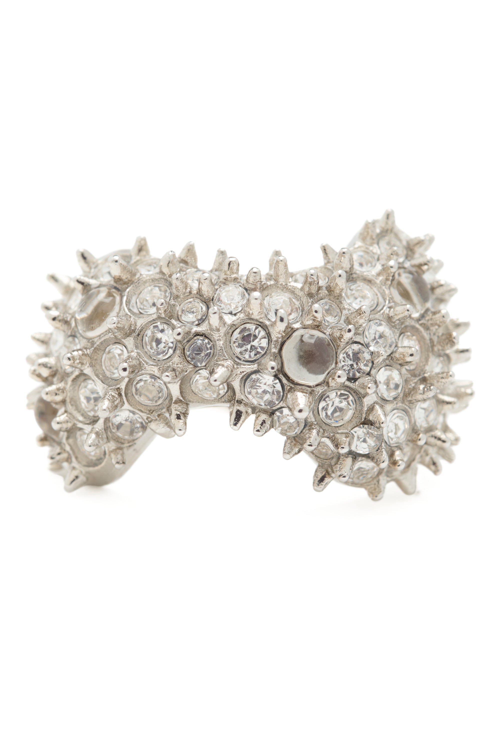 Silver ring encrusted with clear gemstones and mini spikes on a white background