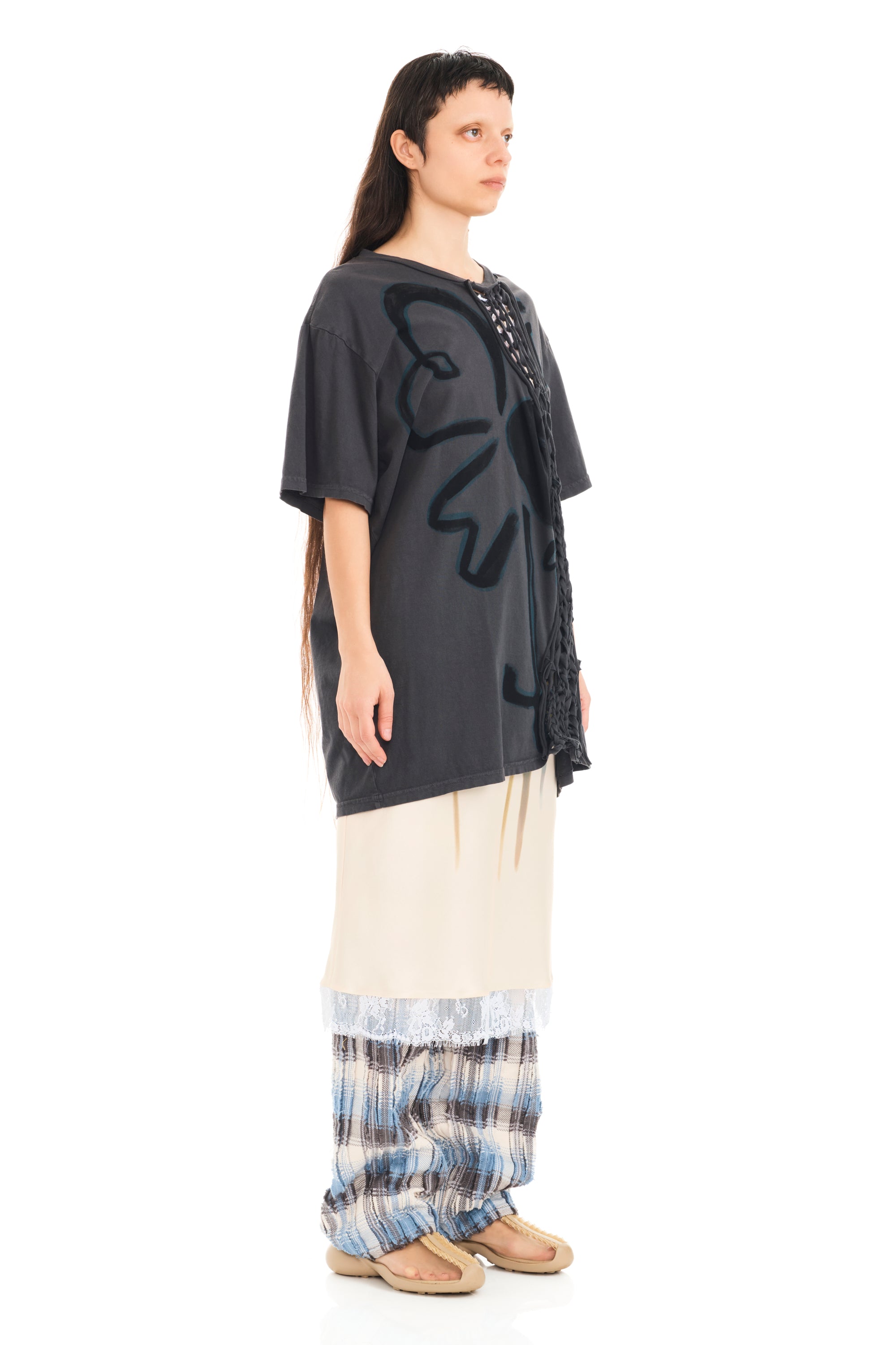 Tee with raw edge openings and knitted detail. Flower design on front.