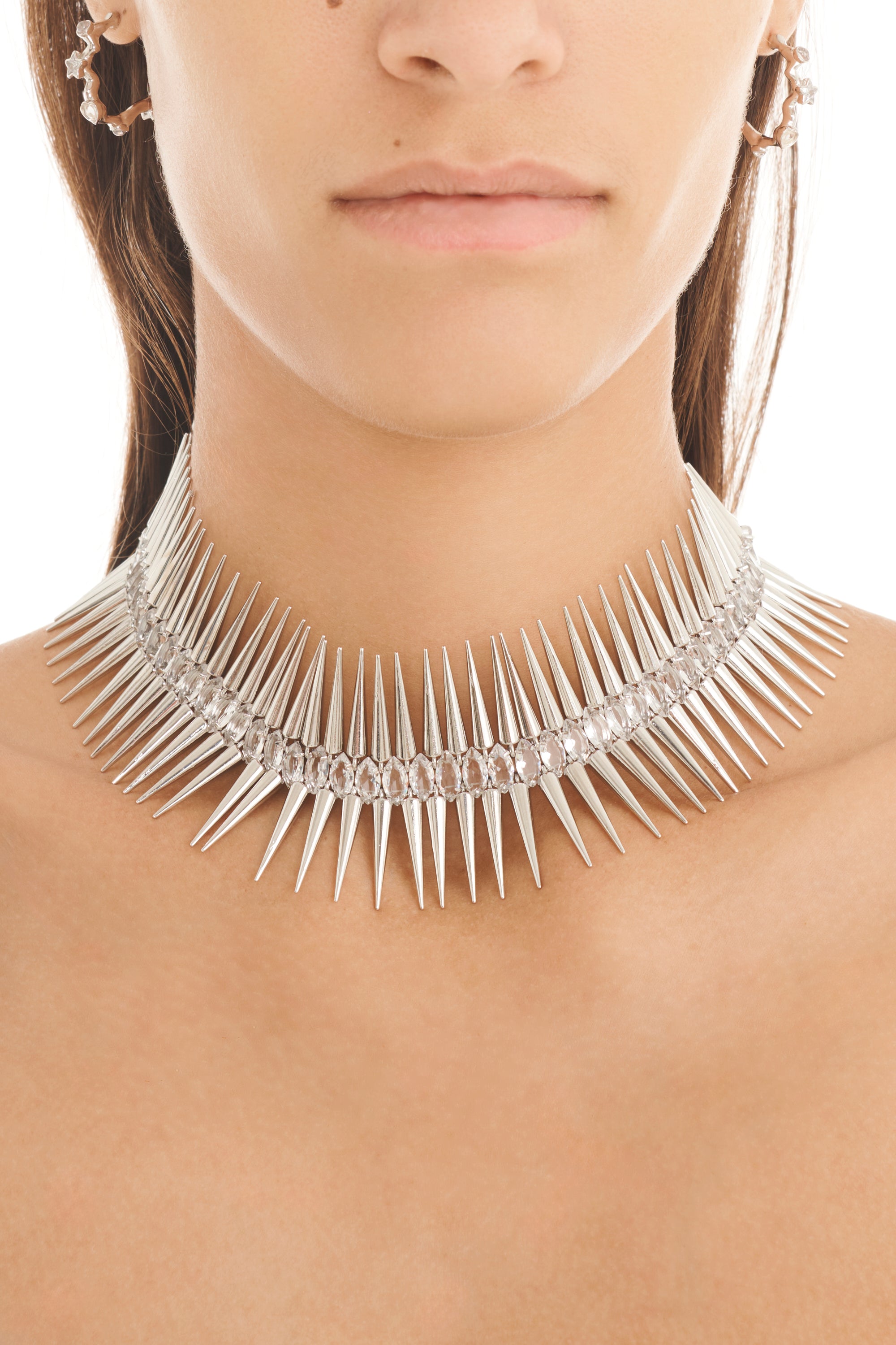 Silver spiked choker necklace worn by a model on a plain background