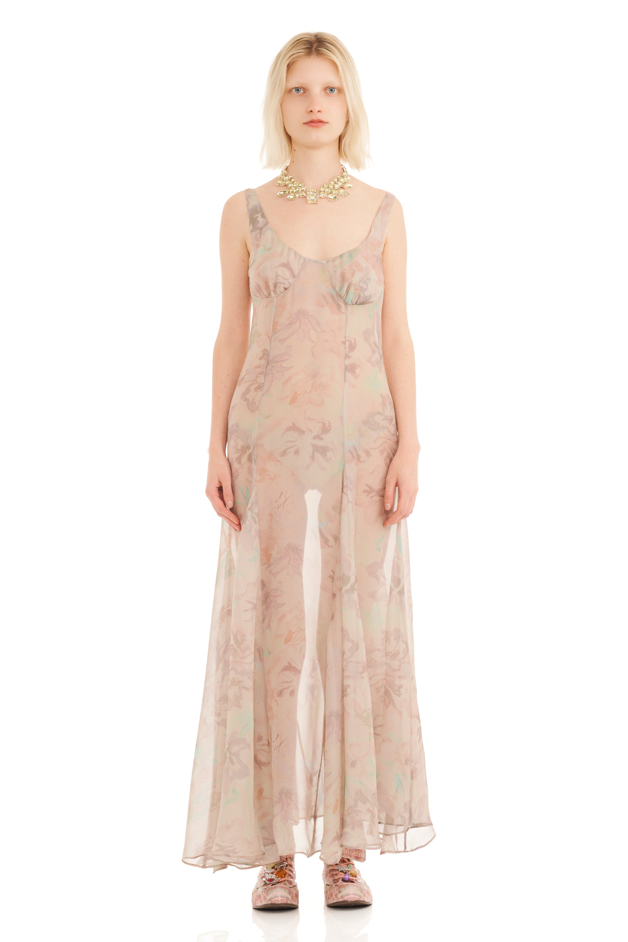Woman wearing a sheer floral tank dress on a white background