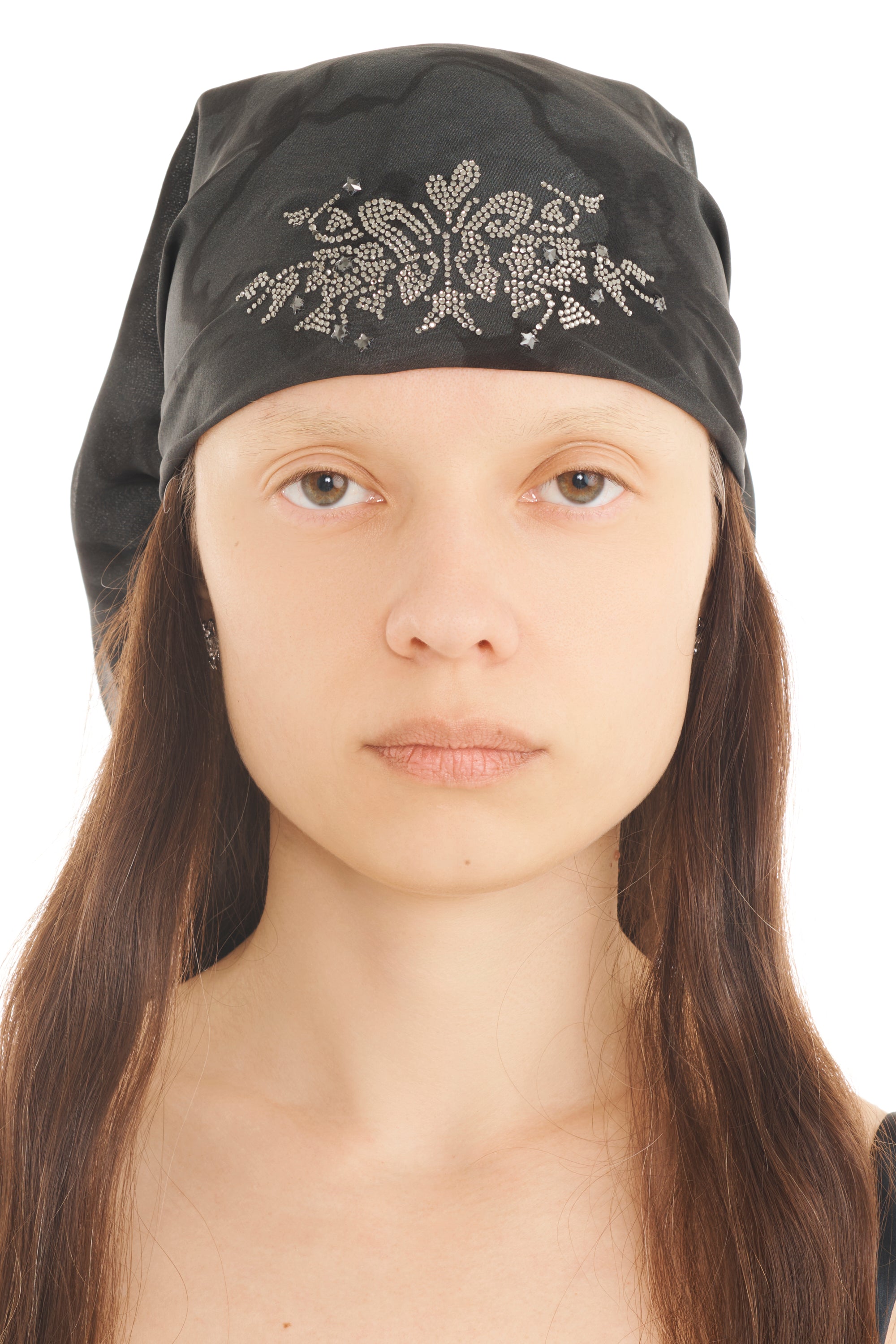 A model wears a black watercolor patterend foulard head scarf with rhinestone detailing on a white background