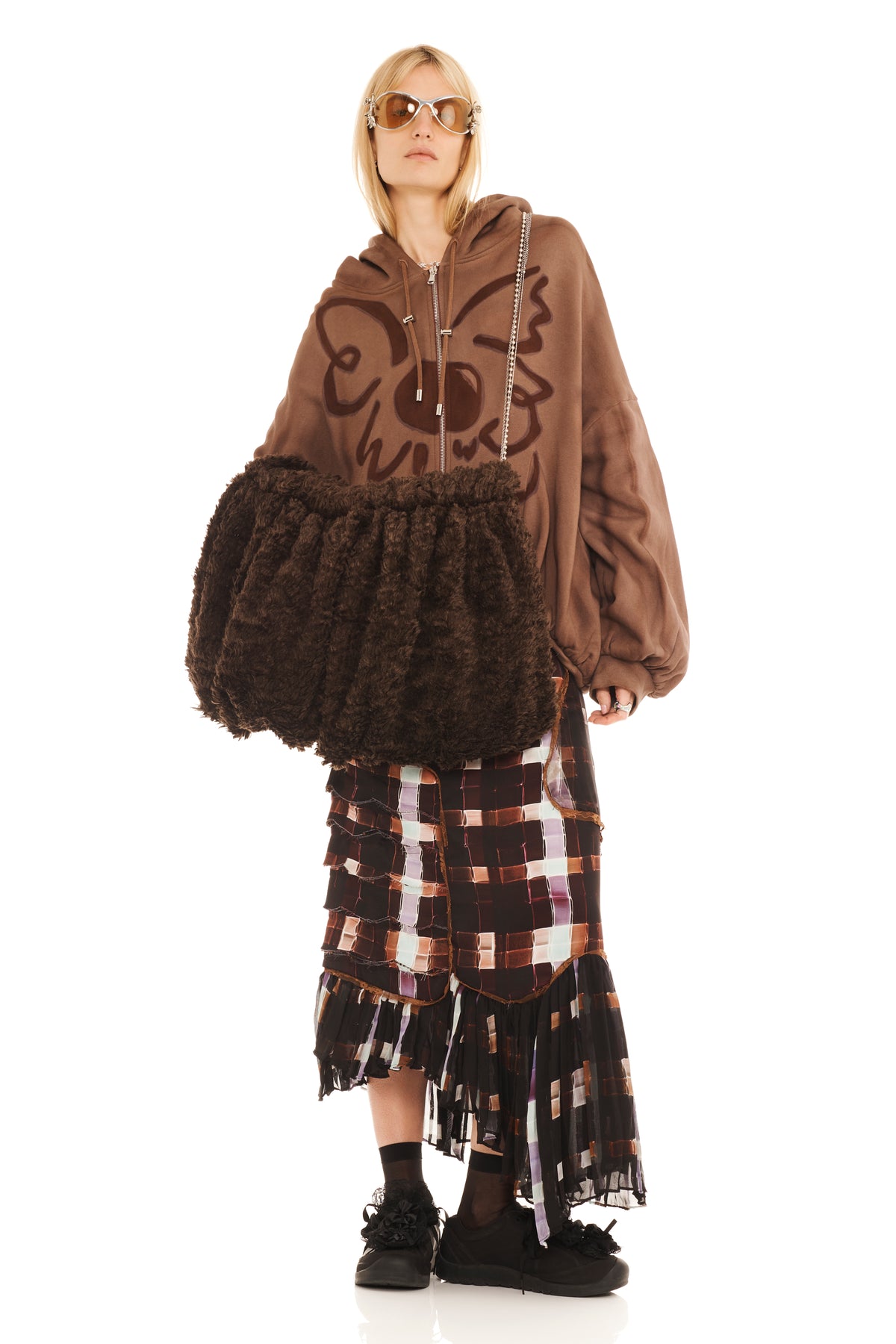 Brown CAPRETTA VALERIAN MUFF BAG worn by a model in an oversized hoodie