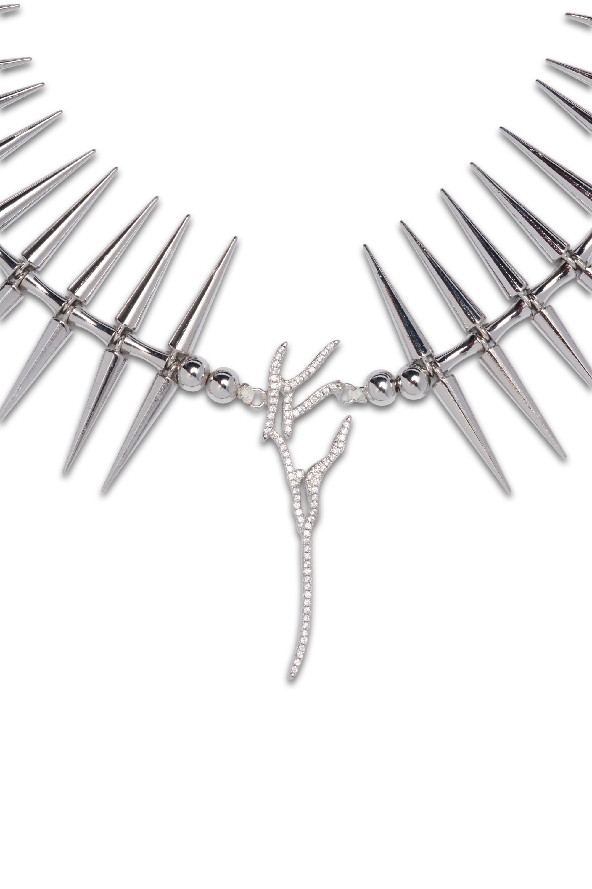Spiky necklace with crystal pave wing at center. Swarovski crystals and plated brass.